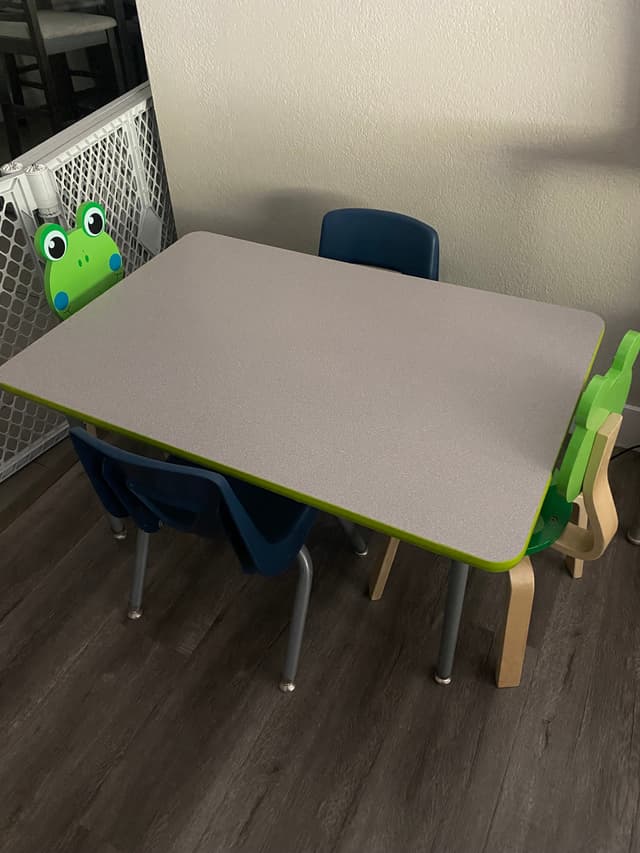 picture of a kids table in a daycare where little kids can draw and play games